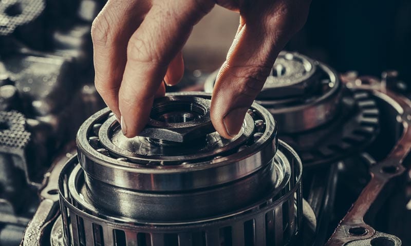 Hydra-Tech Transmissions - close-up of hands doing mechanical work on a vehicle