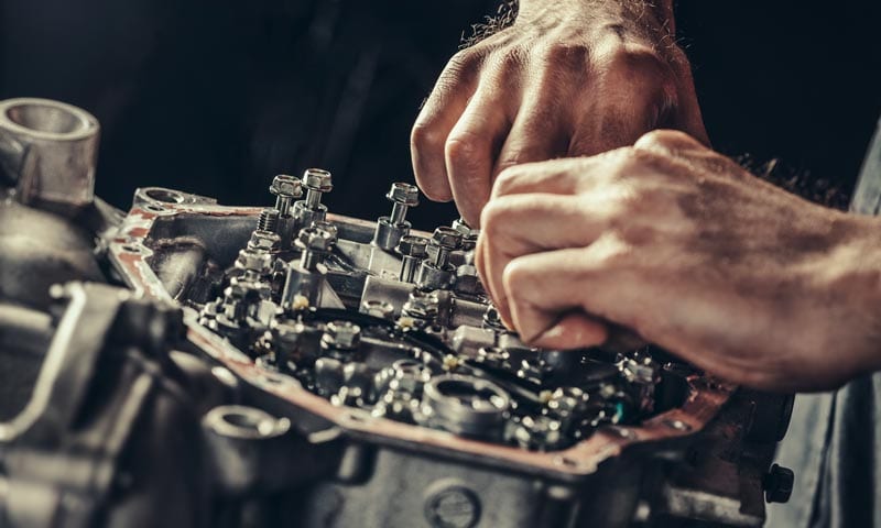Hydra-Tech Transmissions - close-up of hands doing mechanical work on a vehicle