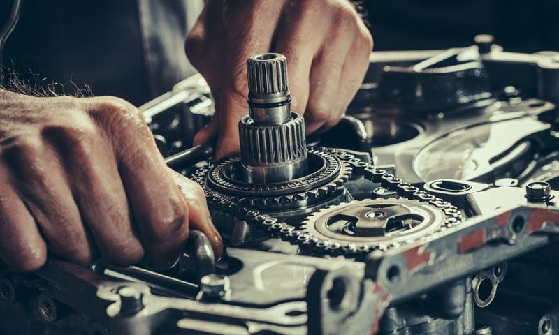 Hydra-Tech Transmissions - close-up of hands doing mechanical work on a vehicle